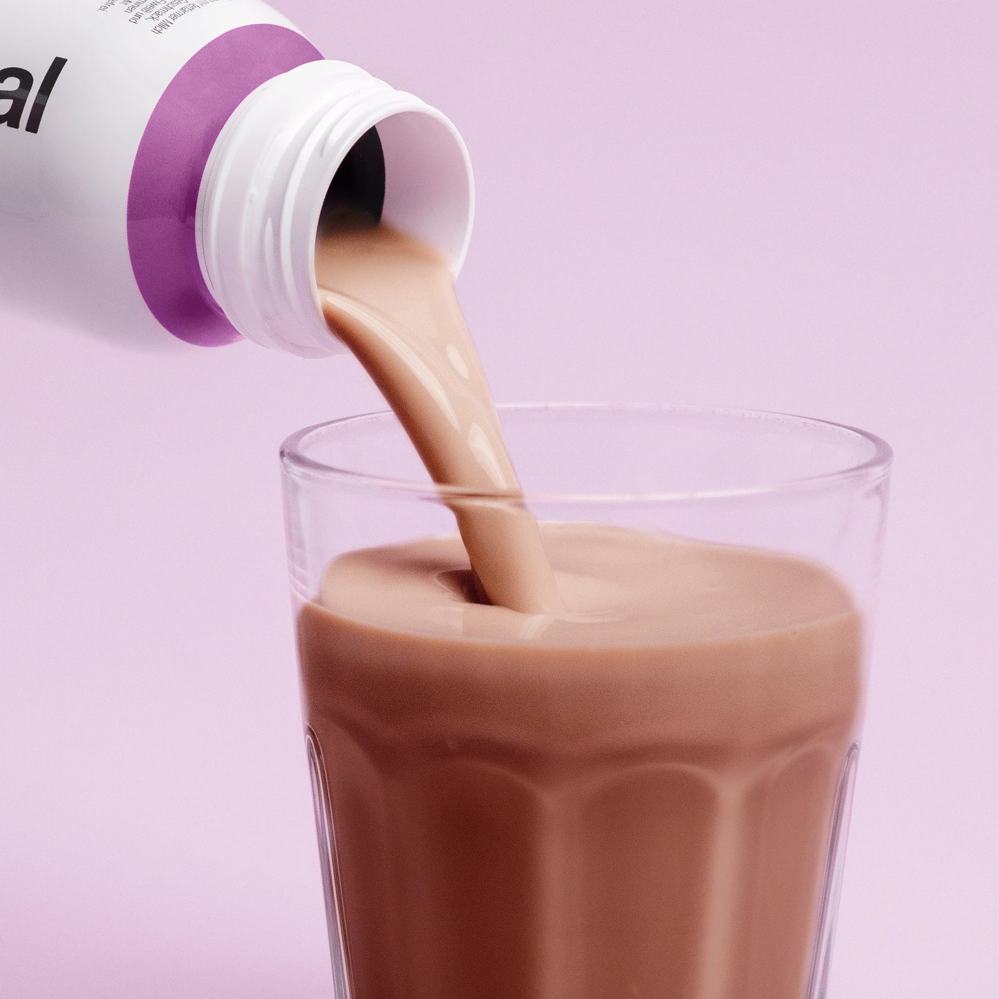 Pouring Nupo One Meal RTD Chocolate shake into glass