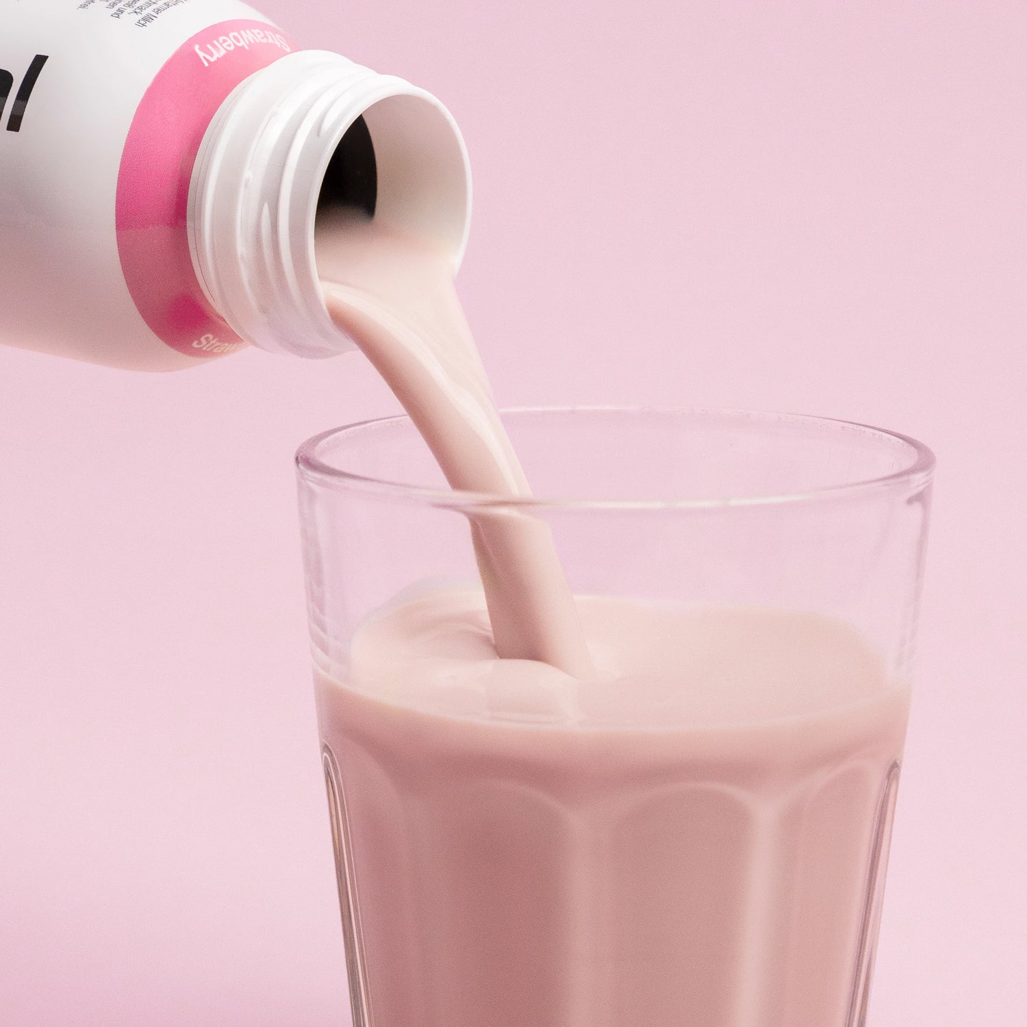 Pouring Nupo One Meal RTD Strawberry shake into glass