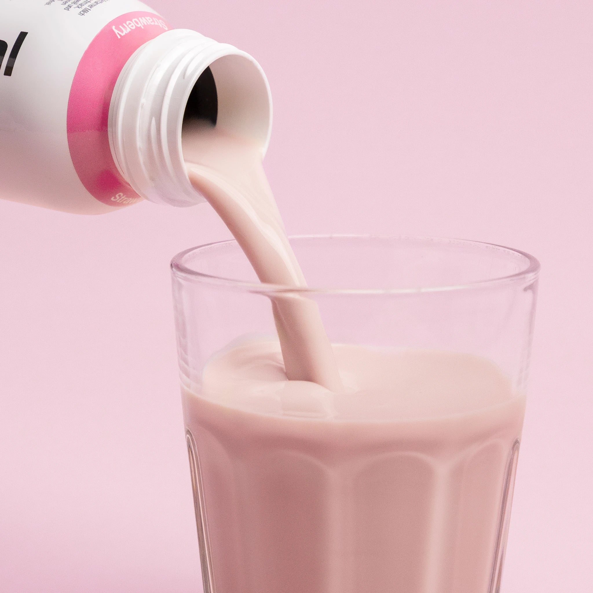 Pouring Nupo One Meal RTD Strawberry shake into glass