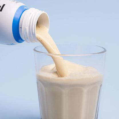 Pouring Nupo One Meal RTD Vanilla shake into glass